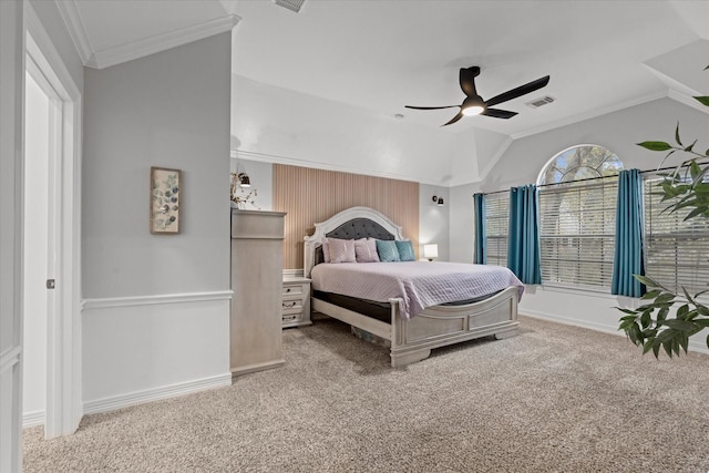 carpeted bedroom featuring crown molding, vaulted ceiling, and ceiling fan