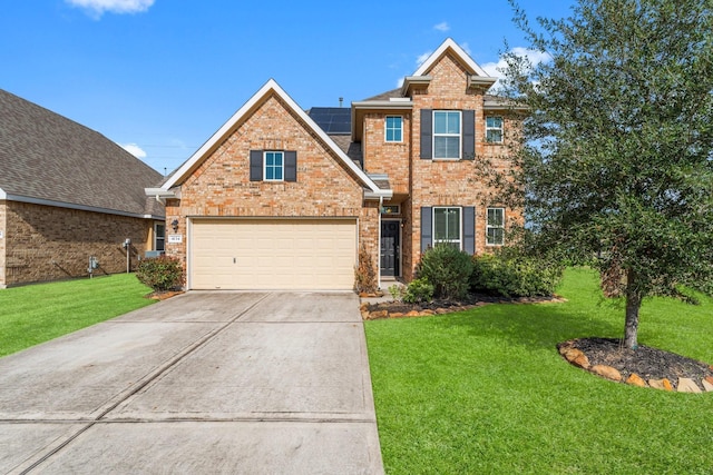 view of front of home featuring a garage, a front yard, and solar panels