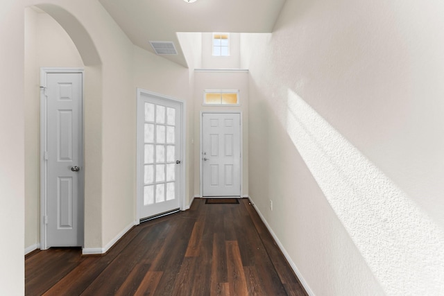 entryway featuring dark wood-type flooring and a high ceiling