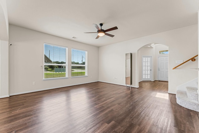 unfurnished living room with dark hardwood / wood-style floors and ceiling fan