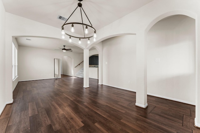 unfurnished living room with ceiling fan and dark wood-type flooring