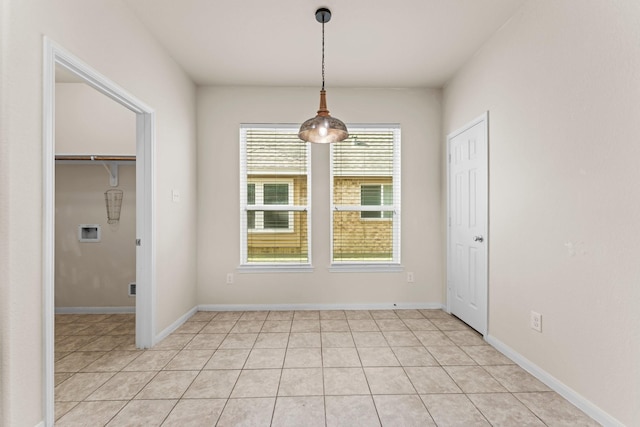 unfurnished dining area featuring light tile patterned flooring