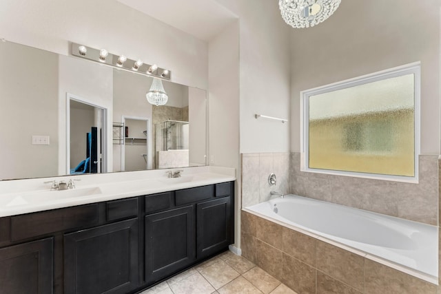 bathroom with plus walk in shower, tile patterned floors, and vanity