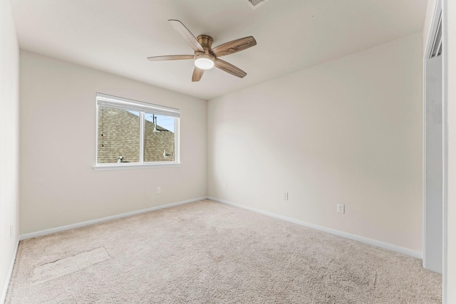 empty room with ceiling fan and light colored carpet