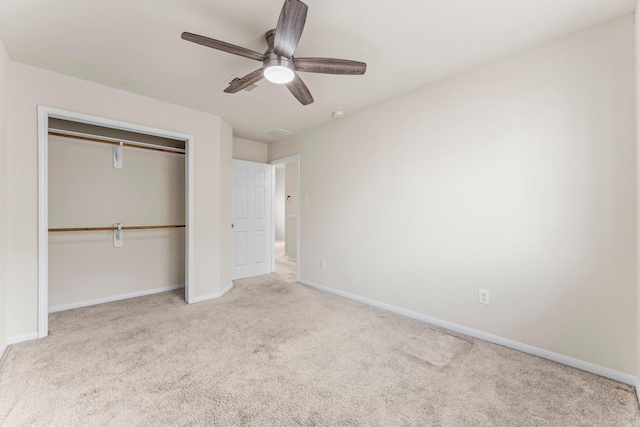 unfurnished bedroom with ceiling fan, a closet, and light carpet