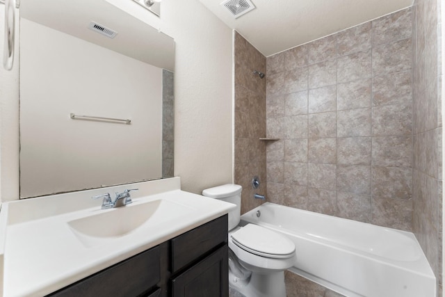 full bathroom featuring vanity, toilet, and tiled shower / bath