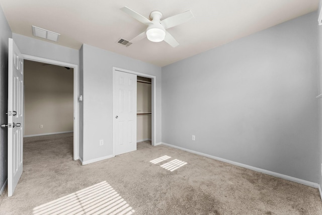 unfurnished bedroom with light colored carpet, a closet, and ceiling fan