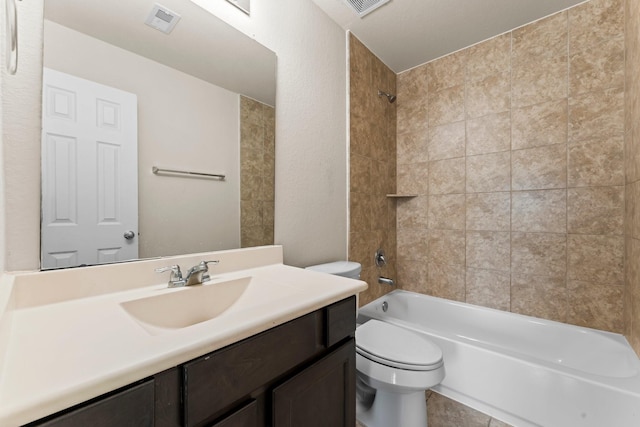 full bathroom featuring vanity, toilet, and tiled shower / bath