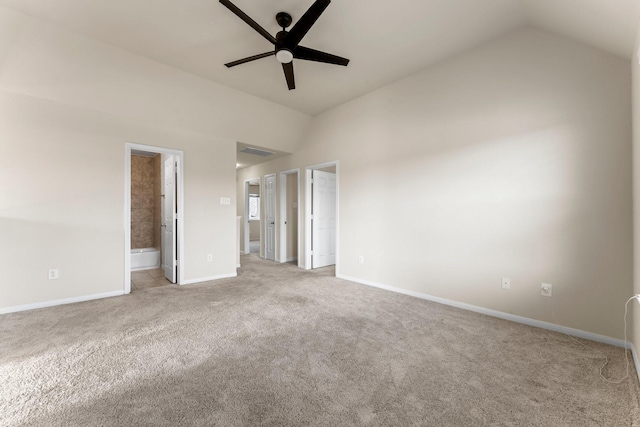 unfurnished bedroom with ceiling fan, connected bathroom, light carpet, and lofted ceiling