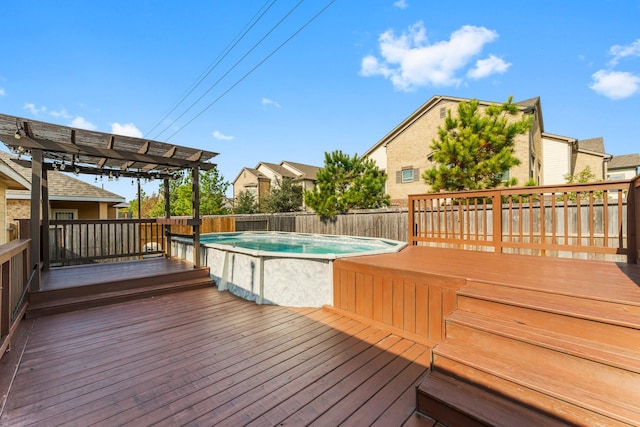 wooden deck with a fenced in pool and a pergola