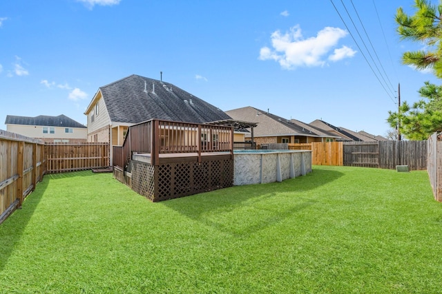 view of yard with a pool side deck