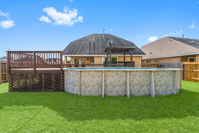 view of pool featuring a deck, a pergola, and a lawn