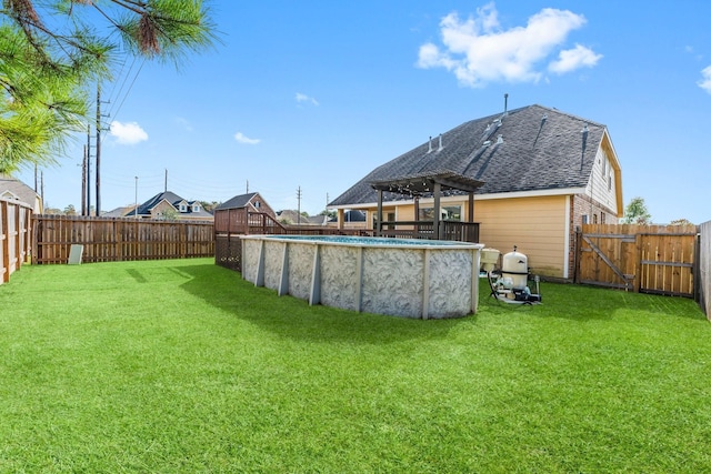 view of yard with a fenced in pool and a pergola