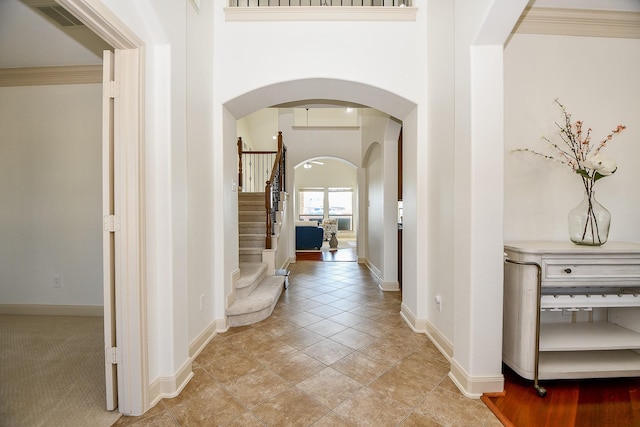 tiled foyer entrance featuring ornamental molding