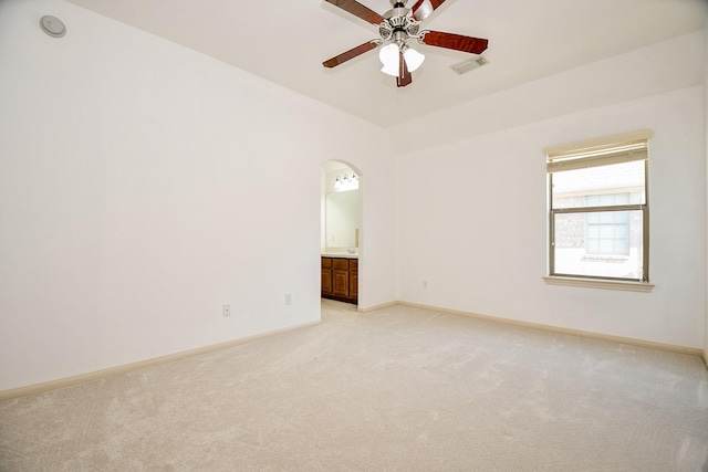 carpeted spare room with lofted ceiling and ceiling fan