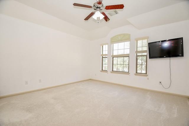 spare room featuring ceiling fan, lofted ceiling, and carpet flooring