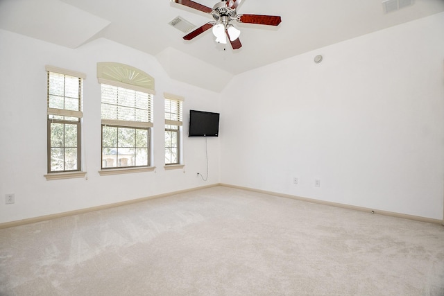 carpeted spare room with lofted ceiling and ceiling fan