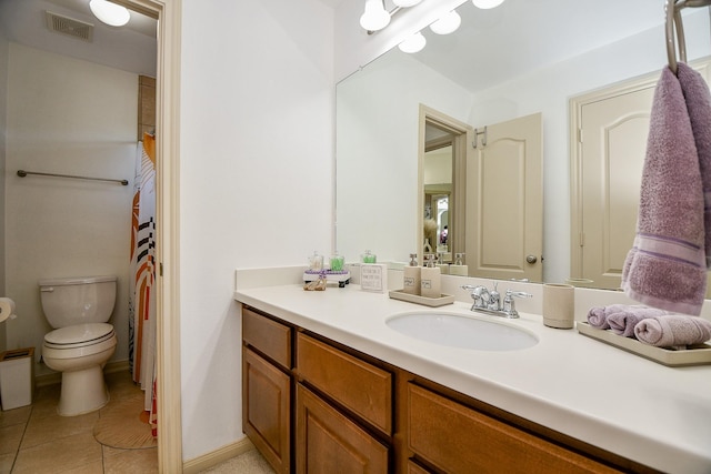 bathroom with vanity, tile patterned floors, and toilet