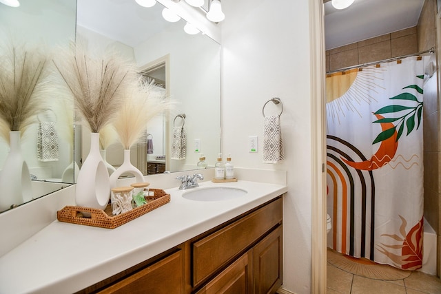 bathroom featuring vanity, a shower with shower curtain, tile patterned floors, and toilet