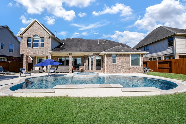 view of pool with an in ground hot tub, a yard, and a patio