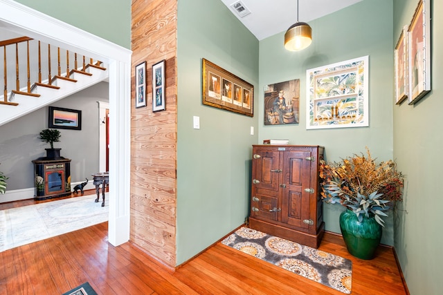 hallway featuring hardwood / wood-style flooring and wood walls