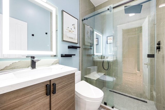 bathroom with vanity, a shower with shower door, and toilet