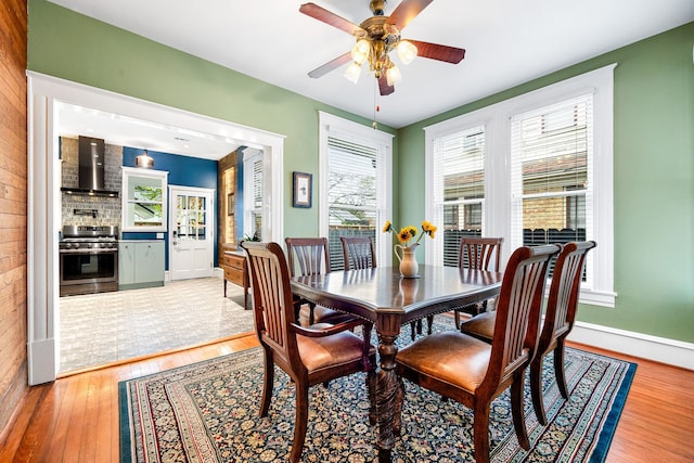 dining space featuring ceiling fan and light wood-type flooring