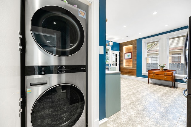 clothes washing area with stacked washer and clothes dryer