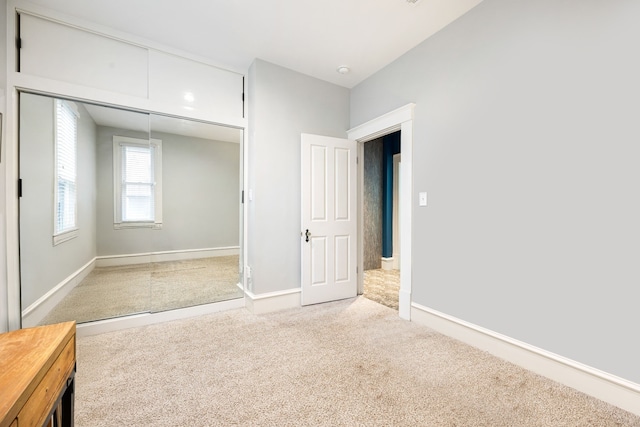 unfurnished bedroom with a closet and carpet