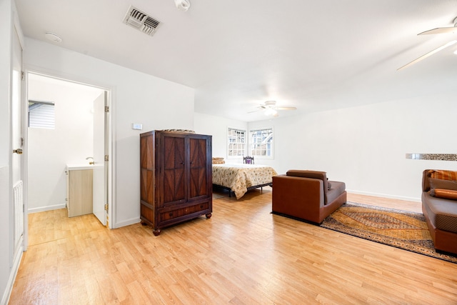 bedroom with light hardwood / wood-style floors and ceiling fan