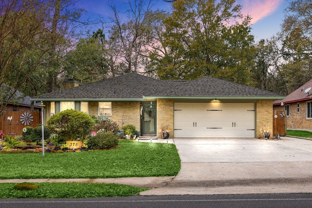 view of front facade with a lawn and a garage