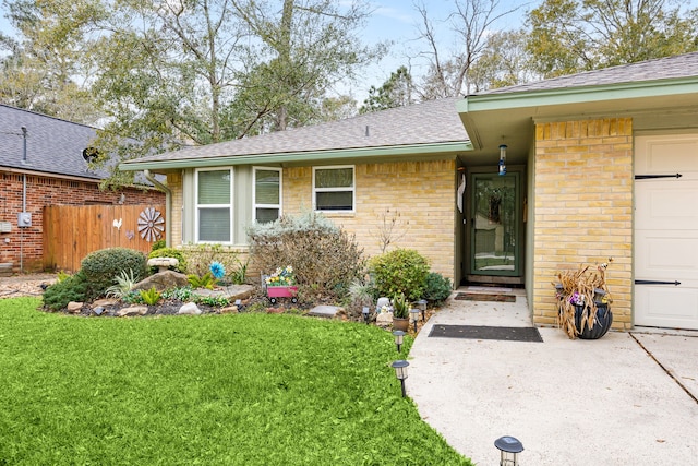 property entrance with a lawn