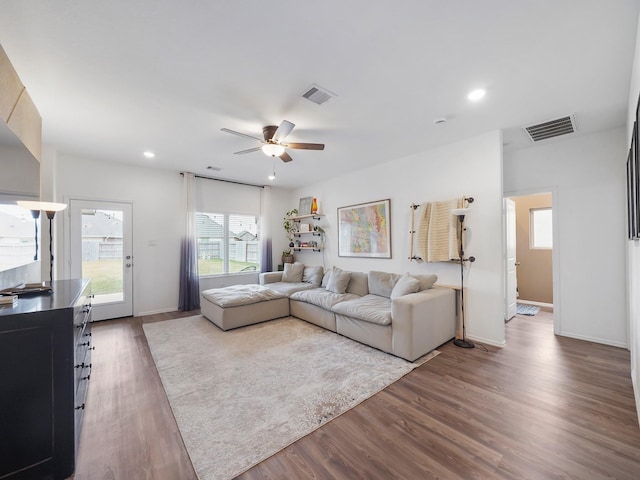 living room featuring ceiling fan and wood-type flooring