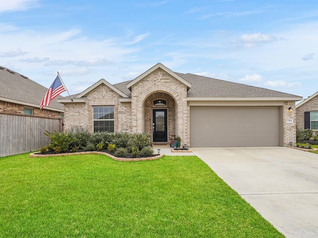 ranch-style home with a garage and a front yard