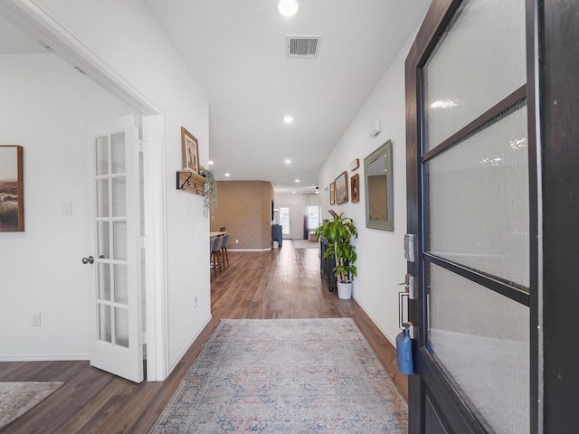 hallway with dark hardwood / wood-style floors