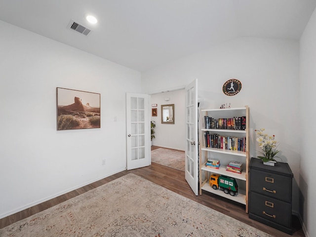 spare room featuring dark wood-type flooring and french doors