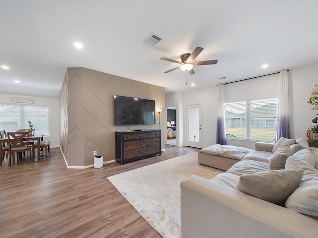 living room featuring hardwood / wood-style floors, a healthy amount of sunlight, and ceiling fan