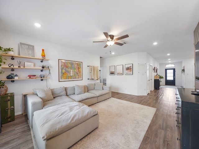 living room featuring ceiling fan and wood-type flooring