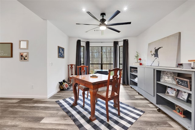 dining area with ceiling fan and wood-type flooring