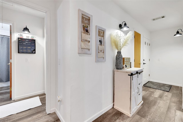 corridor with hardwood / wood-style flooring