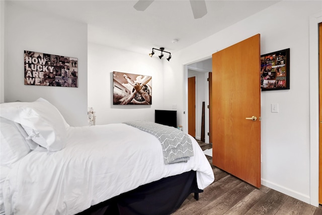 bedroom with ceiling fan and dark hardwood / wood-style flooring