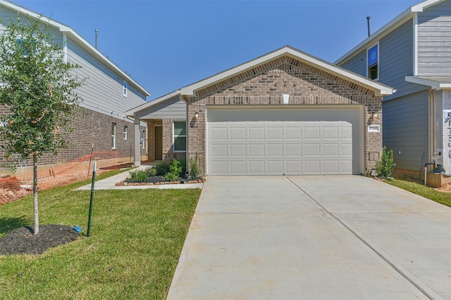 view of front of house featuring a front yard and a garage