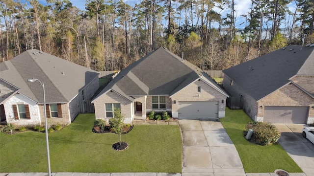 view of front of property featuring a garage and a front yard