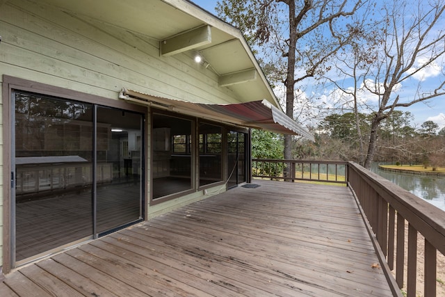 wooden terrace featuring a water view