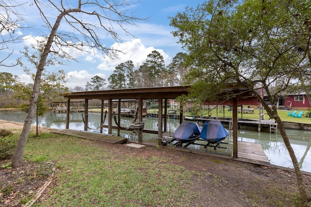 view of dock featuring a water view and a lawn