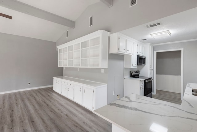 kitchen with white cabinetry, vaulted ceiling with beams, stainless steel appliances, and light wood-type flooring