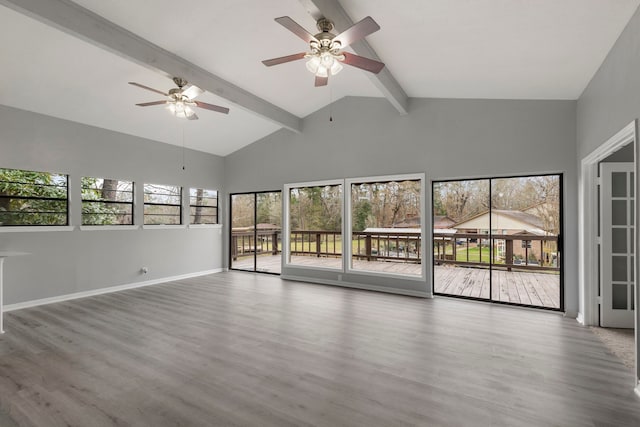 interior space featuring hardwood / wood-style flooring, ceiling fan, and vaulted ceiling with beams