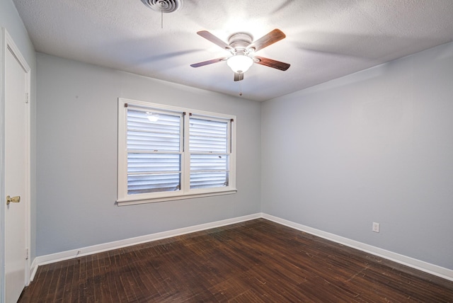 unfurnished room with ceiling fan, dark wood-type flooring, and a textured ceiling