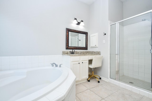 bathroom featuring tile patterned floors, vanity, and shower with separate bathtub