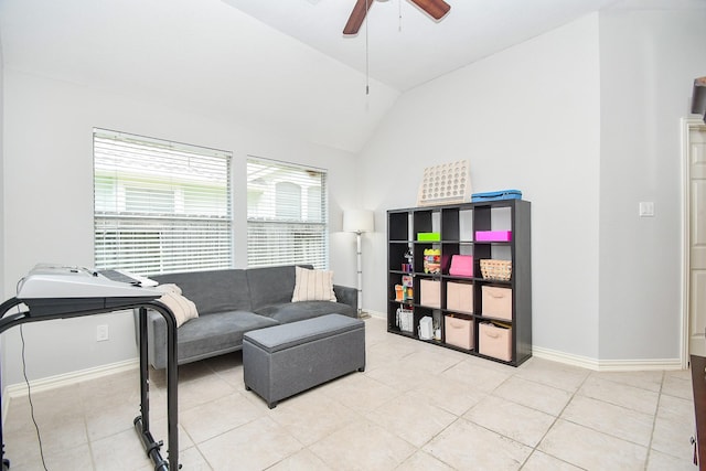 living room featuring ceiling fan, light tile patterned floors, and lofted ceiling